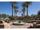 Community fountain and common area, surrounded by trees and lush landscaping at 5644 N 206Th Gln, Buckeye, AZ 85396