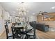 Modern dining room featuring decorative lighting and an open floor plan with access to the living room and kitchen at 5644 N 206Th Gln, Buckeye, AZ 85396