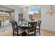 Dining area featuring a modern chandelier, a table set for six, and a scenic view of the mountains outside the window at 5644 N 206Th Gln, Buckeye, AZ 85396