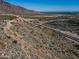 Scenic hillside view of the community with walking path, desert landscape, and distant views at 5644 N 206Th Gln, Buckeye, AZ 85396