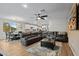 Spacious living room showcasing a leather sofa and decorative area rug in an open layout near the dining and kitchen areas at 5644 N 206Th Gln, Buckeye, AZ 85396