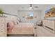 Comfortable main bedroom with neutral walls, carpet flooring, ceiling fan, stylish furniture and a window with plantation shutters at 5644 N 206Th Gln, Buckeye, AZ 85396