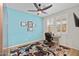 Bright home office with hardwood floors, ceiling fan, and plantation shutters at 5644 N 206Th Gln, Buckeye, AZ 85396