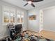 Well-lit office featuring a ceiling fan, plantation shutters, and stylish decor at 5644 N 206Th Gln, Buckeye, AZ 85396