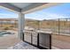 Outdoor kitchen under a covered patio, featuring a built-in grill and stunning mountain views at 5644 N 206Th Gln, Buckeye, AZ 85396