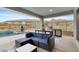 Covered patio area with outdoor kitchen, built-in grill, a swimming pool, and mountain views at 5644 N 206Th Gln, Buckeye, AZ 85396