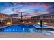 An alluring swimming pool and spa illuminated at twilight, perfect for evening relaxation at 5644 N 206Th Gln, Buckeye, AZ 85396