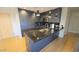 Modern kitchen with sleek, dark cabinetry, granite countertops, and stainless steel appliances at 7147 E Rancho Vista Dr # 7004, Scottsdale, AZ 85251
