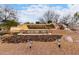 Attractive Mountainbrook Village entrance with waterfall feature, sign and natural landscaping at 7195 E Canyon Wren Dr, Gold Canyon, AZ 85118