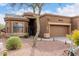 Inviting desert home featuring a lovely garden, a tiled roof, and attached two-car garage at 7195 E Canyon Wren Dr, Gold Canyon, AZ 85118