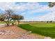 Beautiful golf course view with a path leading to the green and neighborhood in the background at 7195 E Canyon Wren Dr, Gold Canyon, AZ 85118