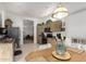 Well-lit eat-in kitchen area with tile floors, wood cabinets, and stainless steel refrigerator at 7195 E Canyon Wren Dr, Gold Canyon, AZ 85118