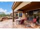 Outdoor dining area with patio furniture set on stone tile with views of the yard at 7195 E Canyon Wren Dr, Gold Canyon, AZ 85118