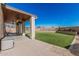 Backyard featuring a covered porch, artificial turf, and low-maintenance desert landscaping at 7531 W Rock Springs Dr, Peoria, AZ 85383