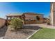 Spacious backyard featuring a pergola, landscaped area, and artificial grass, perfect for outdoor entertaining at 7531 W Rock Springs Dr, Peoria, AZ 85383