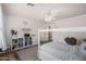 Bright bedroom with white trim, ceiling fan, laminate wood flooring, and four-poster bed at 7531 W Rock Springs Dr, Peoria, AZ 85383