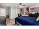 Relaxing bedroom with natural light, wood floors, ceiling fan, and decorative wall art at 7531 W Rock Springs Dr, Peoria, AZ 85383