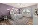 Charming bedroom with custom canopy bed frame, purple mural, and natural light at 7531 W Rock Springs Dr, Peoria, AZ 85383