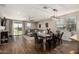 This dining room and living room area feature wood floors and lots of natural light from the sliding glass doors at 7531 W Rock Springs Dr, Peoria, AZ 85383