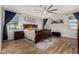 This bedroom features natural light, a decorative ceiling fan, and wood-look flooring at 7531 W Rock Springs Dr, Peoria, AZ 85383