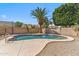 Backyard pool with updated concrete decking, desert landscaping, and a rock feature at 7919 E Posada Ave, Mesa, AZ 85212