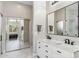 Bright bathroom featuring double sinks with marble countertop and tiled floors at 7919 E Posada Ave, Mesa, AZ 85212