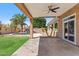 Covered patio provides shade and overlooks the manicured lawn and backyard pool at 7919 E Posada Ave, Mesa, AZ 85212