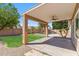 Covered patio overlooking the manicured lawn, desert landscaping, and sparkling pool at 7919 E Posada Ave, Mesa, AZ 85212