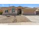 Single-story home featuring desert landscaping, a tile roof, and a two-car garage at 7919 E Posada Ave, Mesa, AZ 85212