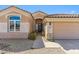 Front exterior of the house with a tile roof, desert landscaping, and a two-car garage at 7919 E Posada Ave, Mesa, AZ 85212