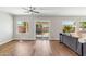 Bright living room with hardwood floors, white trim, natural light, and sliding glass doors to the outside at 7919 E Posada Ave, Mesa, AZ 85212