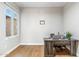 Bright home office with light wood floors, large window, desk, and white trim at 7919 E Posada Ave, Mesa, AZ 85212