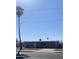 Single-story home featuring a low-pitched roof, neutral-toned siding, and desert landscaping, complete with mature palm trees at 813 N Trekell Rd, Casa Grande, AZ 85122