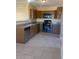 A kitchen featuring brown cabinets, granite countertops, and a tile floor at 813 N Trekell Rd, Casa Grande, AZ 85122