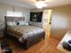 Bedroom with U.S. Army decor, a ceiling fan, a double bed, and wood-look floors at 8600 E Broadway Rd # 22, Mesa, AZ 85208