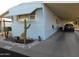 Single-story home with awning and carport; the yard features rocks and desert plants at 8600 E Broadway Rd # 22, Mesa, AZ 85208