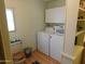 Laundry room with white cabinets, a white washer and dryer, and a wood floor at 8600 E Broadway Rd # 22, Mesa, AZ 85208