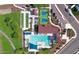 Stunning aerial view showcases a resort-style community pool, tennis courts, and verdant landscaping at 9336 W Louise Dr, Peoria, AZ 85383