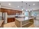 Spacious kitchen features an island with granite countertops, stainless steel appliances, and wooden cabinets at 9336 W Louise Dr, Peoria, AZ 85383