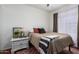 Bedroom with side table, decorative rug, neutral walls, and brown accents at 9420 E Plata Ave, Mesa, AZ 85212