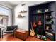 Cozy Den space with shelving, guitars, and a comfortable ottoman seat at 9420 E Plata Ave, Mesa, AZ 85212