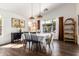 Bright dining room featuring wood floors, a vaulted ceiling and backyard views at 9420 E Plata Ave, Mesa, AZ 85212