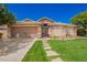 Charming single-story home featuring desert landscaping, stone accents, and a two-car garage at 9420 E Plata Ave, Mesa, AZ 85212