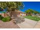 View of a landscaped front yard with desert accents and a lush green lawn at 9420 E Plata Ave, Mesa, AZ 85212