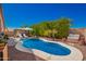 Backyard pool area featuring an in-ground pool, lounge chairs, and mature landscaping at 9420 E Plata Ave, Mesa, AZ 85212