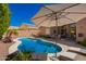 A private in-ground pool with lush landscaping and patio seating for relaxation at 9420 E Plata Ave, Mesa, AZ 85212