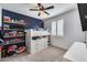 Bright bedroom featuring custom built-ins and a modern bed frame, complemented by a ceiling fan at 9742 W Los Gatos Dr, Peoria, AZ 85383