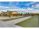 Bocce ball court with concrete walkways and green playing surface near community center, under a blue sky at 9742 W Los Gatos Dr, Peoria, AZ 85383