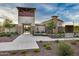 Exterior view of the community center featuring stone accents, landscaped entrance, and gated entryway at 9742 W Los Gatos Dr, Peoria, AZ 85383