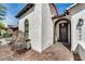 Elegant home entrance with a textured exterior and cobblestone pathway leading to a black front door at 9742 W Los Gatos Dr, Peoria, AZ 85383